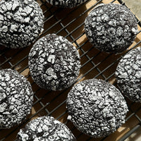 Chocolate cookies with a crumbly topping on a cooling rack