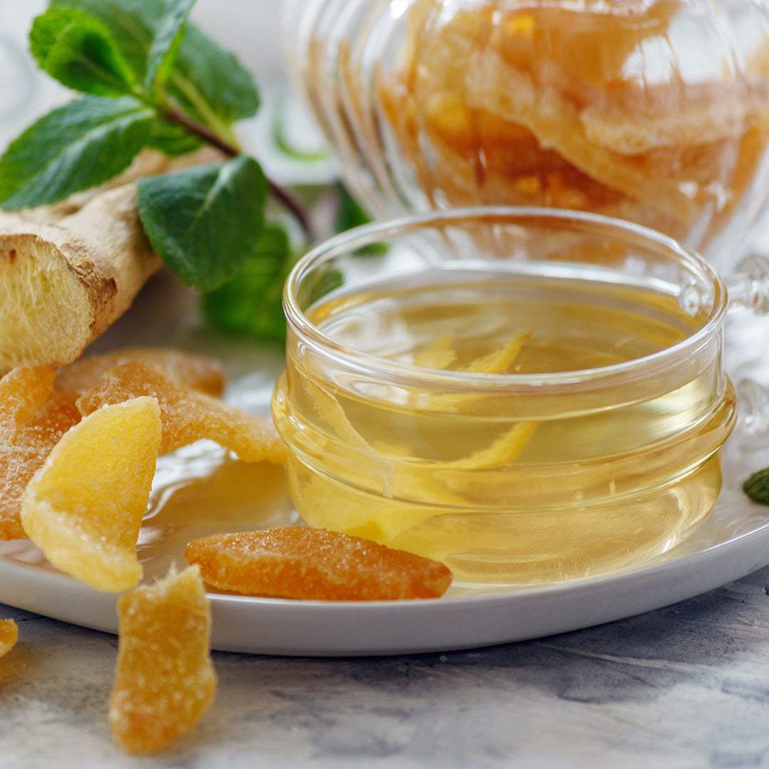Candied Ginger - next to homemade ginger tea on a white platter