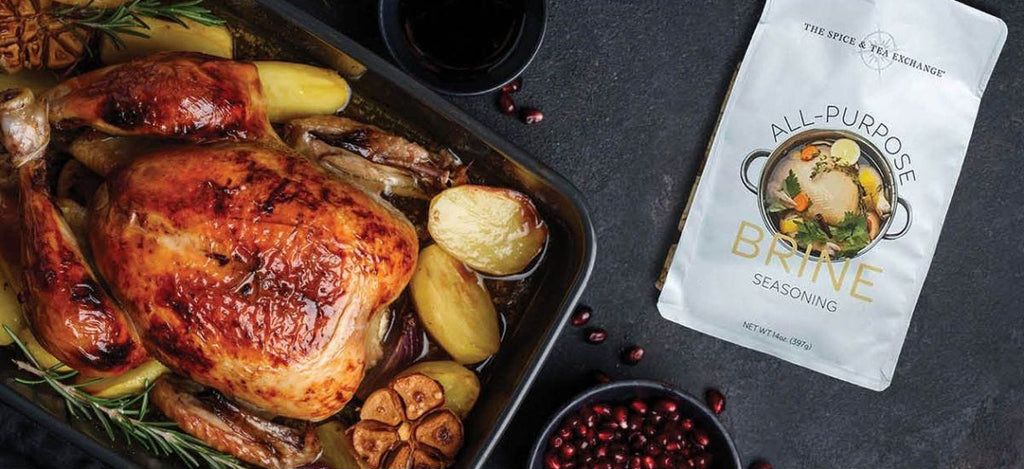 All-Purpose Brine Seasoning sitting next to a perfectly browned turkey in a pan