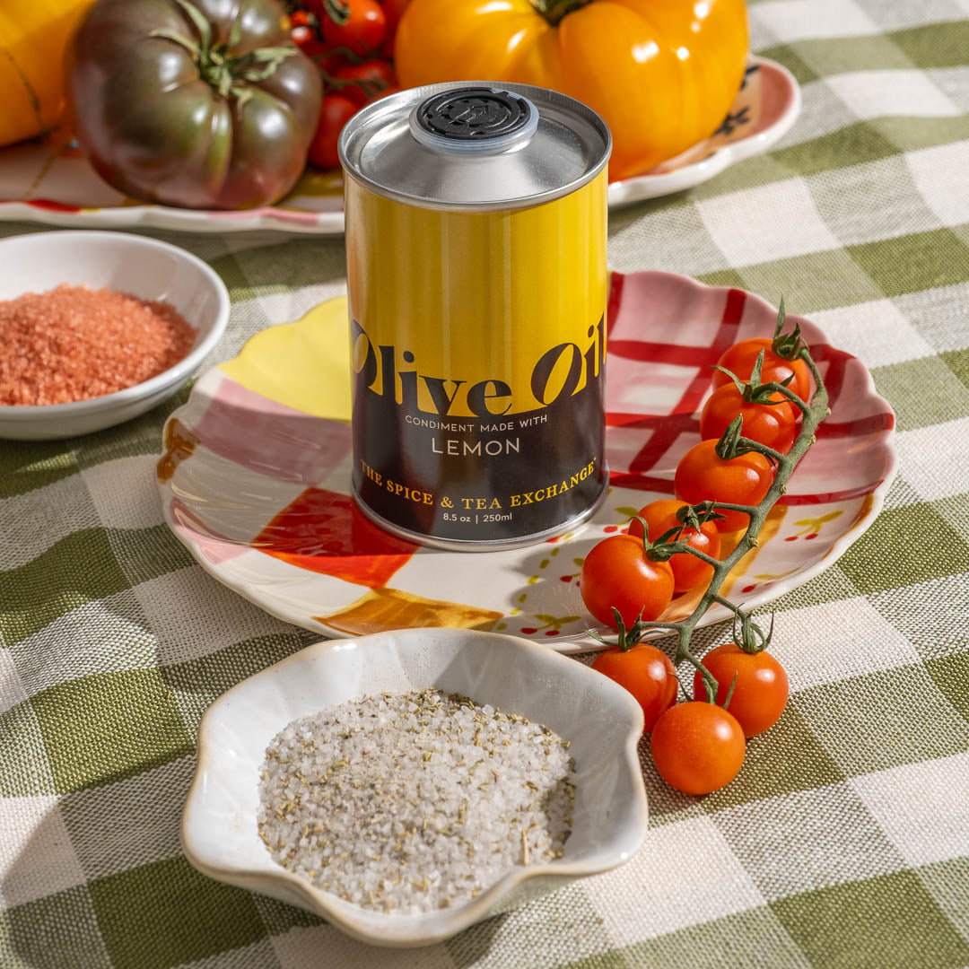 Lemon Extra Virgin Olive Oil on place next to Rosemary sea salt and tomatoes