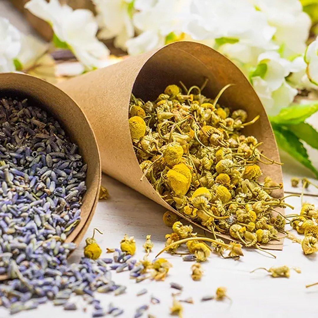 Dried lavender flowers and chamomile flowers in brown sachets.